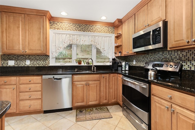 kitchen featuring a sink, backsplash, light tile patterned floors, and stainless steel appliances