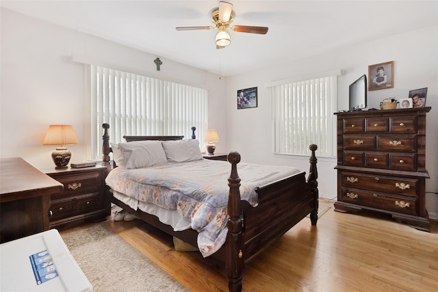 bedroom with a ceiling fan and light wood-style floors