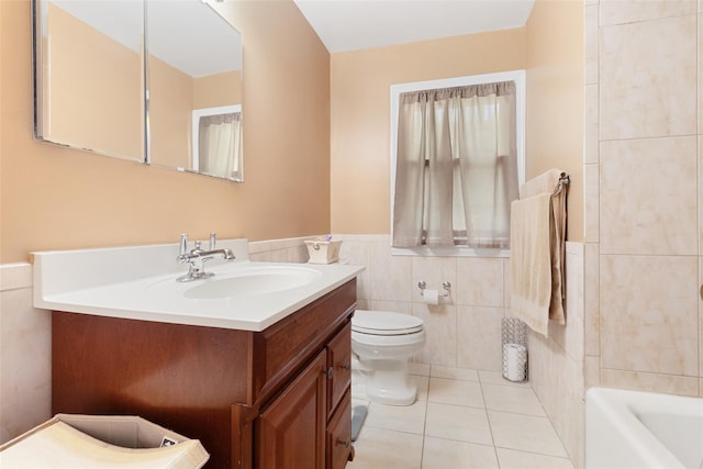 bathroom featuring toilet, wainscoting, tile walls, tile patterned flooring, and vanity