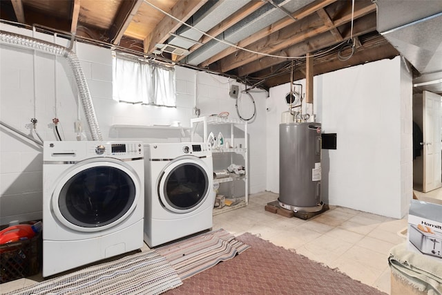 clothes washing area with electric water heater, washer and dryer, and laundry area