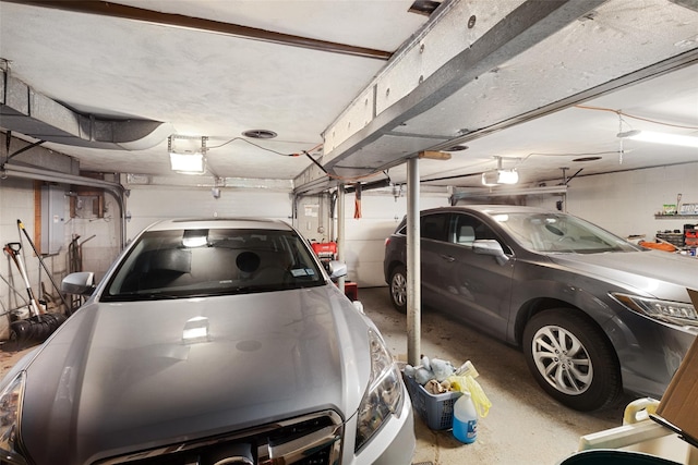 garage with a garage door opener and concrete block wall