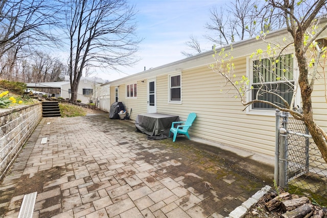 back of property featuring a patio and fence
