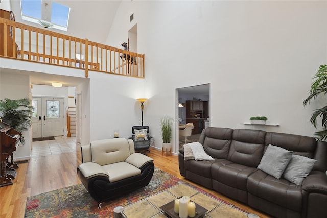 13 Cross Rd, Cortlandt Manor, NY 10567 - living area with a towering ceiling, wood finished floors, baseboards, and a skylight