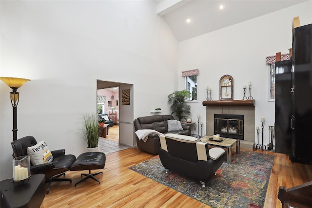 13 Cross Rd, Cortlandt Manor, NY 10567 - living room with wood finished floors, high vaulted ceiling, a tile fireplace, and recessed lighting