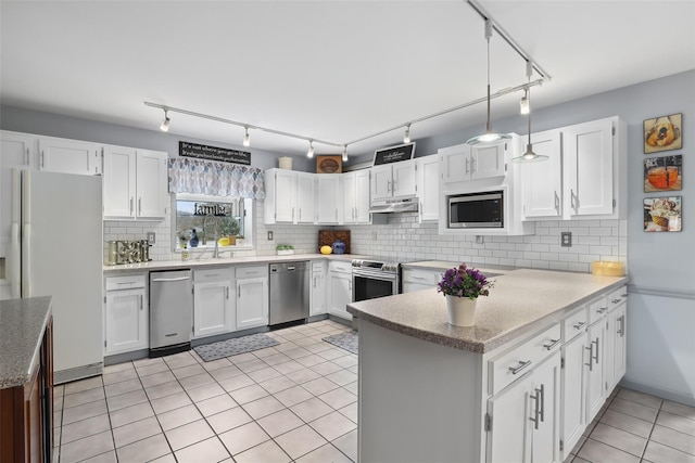13 Cross Rd, Cortlandt Manor, NY 10567 - kitchen with appliances with stainless steel finishes, a peninsula, under cabinet range hood, and white cabinetry