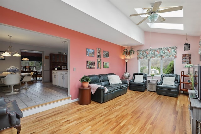 13 Cross Rd, Cortlandt Manor, NY 10567 - living room featuring a skylight, high vaulted ceiling, ceiling fan, and light wood-style floors