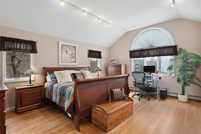 13 Cross Rd, Cortlandt Manor, NY 10567 - bedroom with track lighting, vaulted ceiling, light wood-type flooring, a desk, and baseboard heating