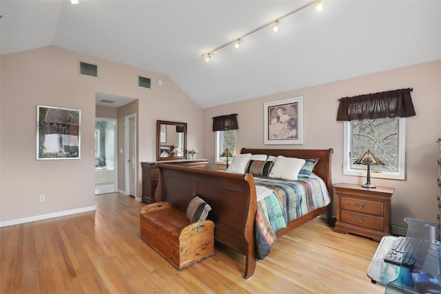 13 Cross Rd, Cortlandt Manor, NY 10567 - bedroom with lofted ceiling, light wood finished floors, baseboards, rail lighting, and ensuite bathroom