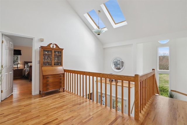 13 Cross Rd, Cortlandt Manor, NY 10567 - hall with high vaulted ceiling, a skylight, wood finished floors, and an upstairs landing