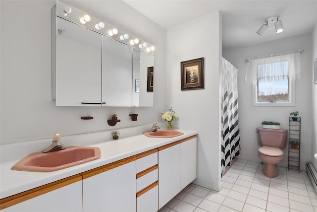 13 Cross Rd, Cortlandt Manor, NY 10567 - bathroom featuring toilet, double vanity, tile patterned flooring, a baseboard radiator, and a shower with shower curtain