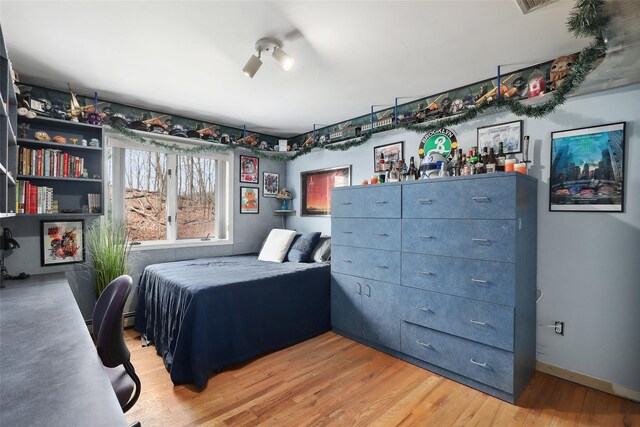 13 Cross Rd, Cortlandt Manor, NY 10567 - bedroom with light wood finished floors and a baseboard radiator
