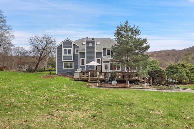13 Cross Rd, Cortlandt Manor, NY 10567 - back of house featuring a deck, a lawn, roof with shingles, and a chimney