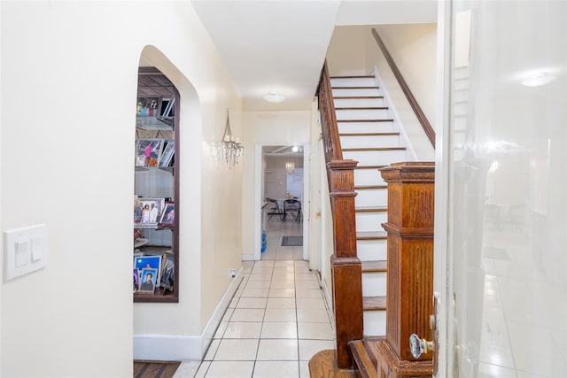 3518 Clarendon Rd, Brooklyn, NY 11203 - corridor featuring stairway, baseboards, arched walkways, and light tile patterned floors