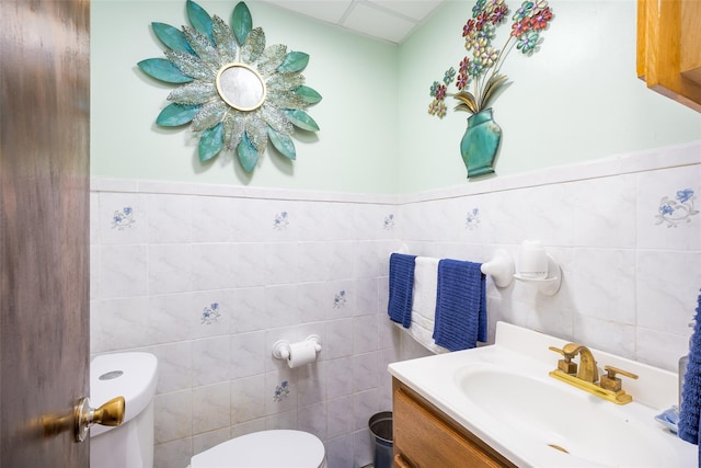3518 Clarendon Rd, Brooklyn, NY 11203 - half bathroom with wainscoting, toilet, vanity, and tile walls