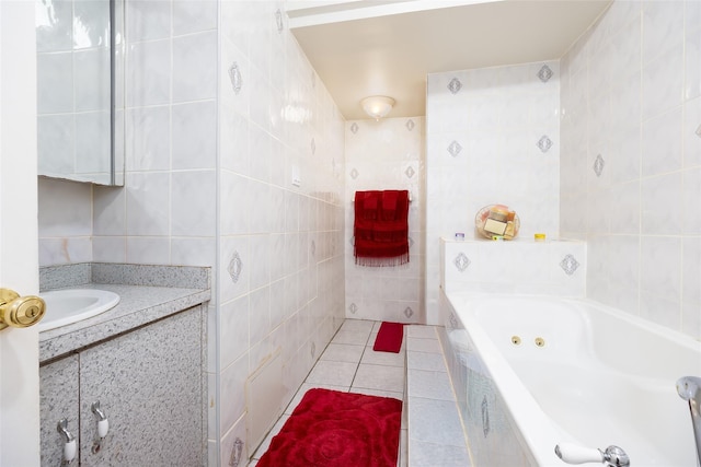 3518 Clarendon Rd, Brooklyn, NY 11203 - bathroom featuring vanity, a tub with jets, tile patterned flooring, and tile walls