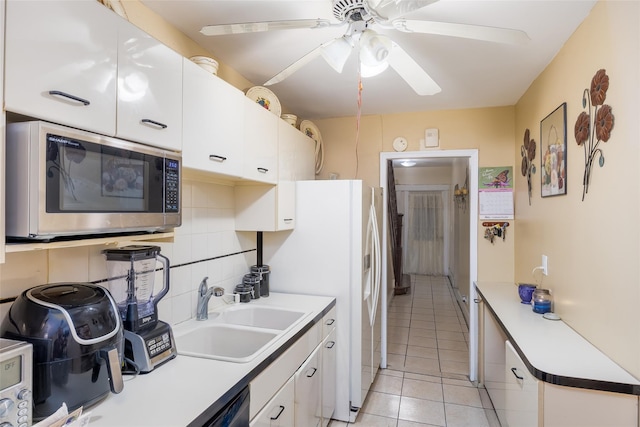 3518 Clarendon Rd, Brooklyn, NY 11203 - kitchen featuring white cabinetry, a sink, stainless steel microwave, and light tile patterned floors