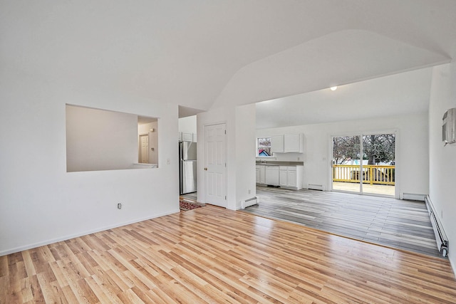 unfurnished living room with a baseboard radiator, light wood-type flooring, and vaulted ceiling