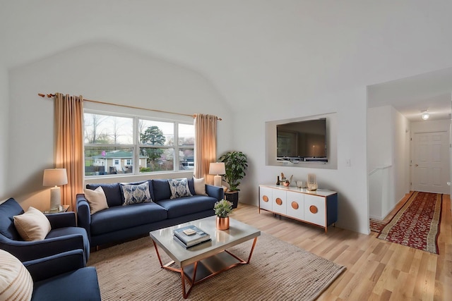 living area featuring light wood finished floors and lofted ceiling