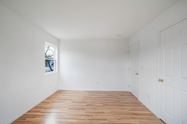 unfurnished bedroom with light wood finished floors and baseboards