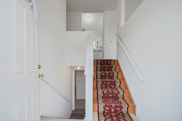 staircase with tile patterned floors