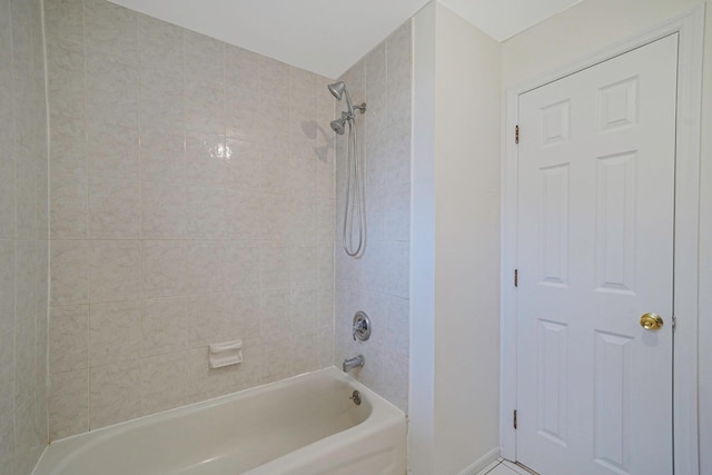 bathroom with baseboards and shower / bathtub combination