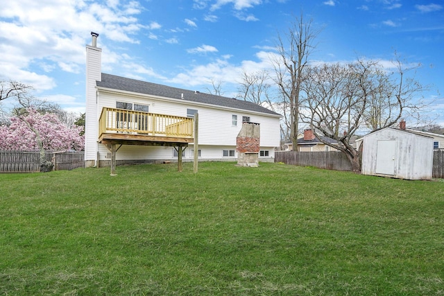 rear view of house with a storage shed, a fenced backyard, an outdoor structure, and a lawn