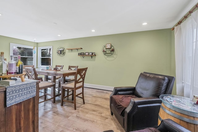 dining room with recessed lighting, light wood-style flooring, and baseboards