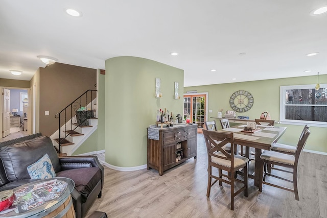 dining space with baseboards, stairway, light wood-style floors, and recessed lighting