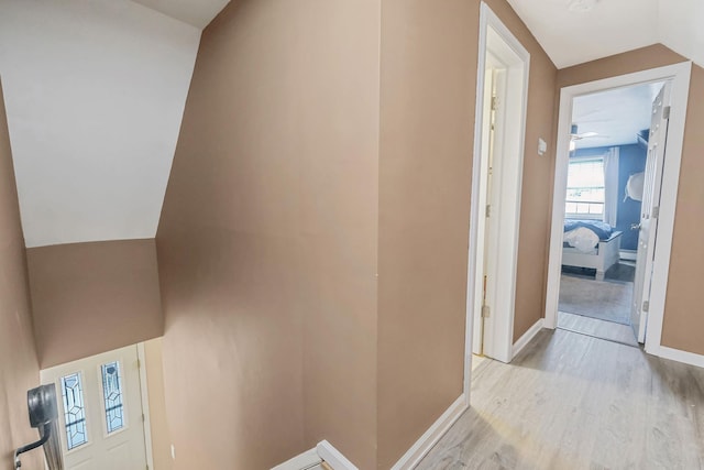 hallway with light wood-style floors and baseboards
