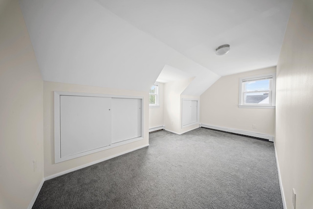 2 Lee Ave, Albertson, NY 11507 - bonus room featuring a healthy amount of sunlight, a baseboard heating unit, vaulted ceiling, and carpet floors