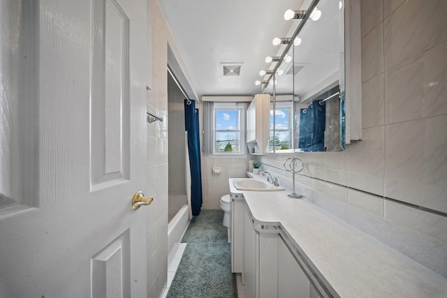 2 Lee Ave, Albertson, NY 11507 - full bath featuring visible vents, toilet, tile walls, shower / bath combo with shower curtain, and vanity