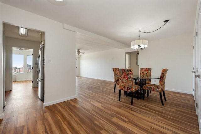 dining area with baseboards, ceiling fan with notable chandelier, and wood finished floors