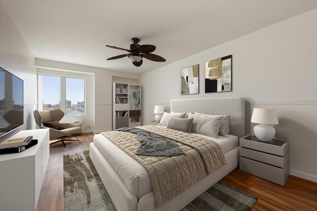 bedroom with baseboards, a ceiling fan, and wood finished floors