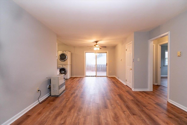 700 Sackett Lake Rd, Monticello, NY 12701 - spare room with stacked washer and dryer, wood finished floors, ceiling fan, and baseboards