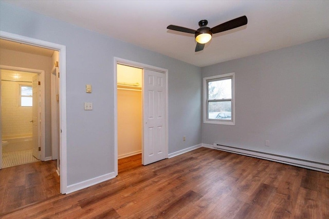 700 Sackett Lake Rd, Monticello, NY 12701 - unfurnished bedroom featuring a closet, baseboards, wood finished floors, and baseboard heating