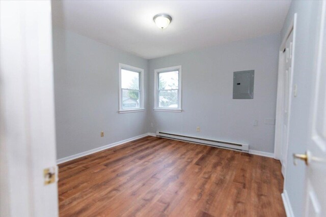 700 Sackett Lake Rd, Monticello, NY 12701 - empty room with a baseboard radiator, wood finished floors, baseboards, and electric panel