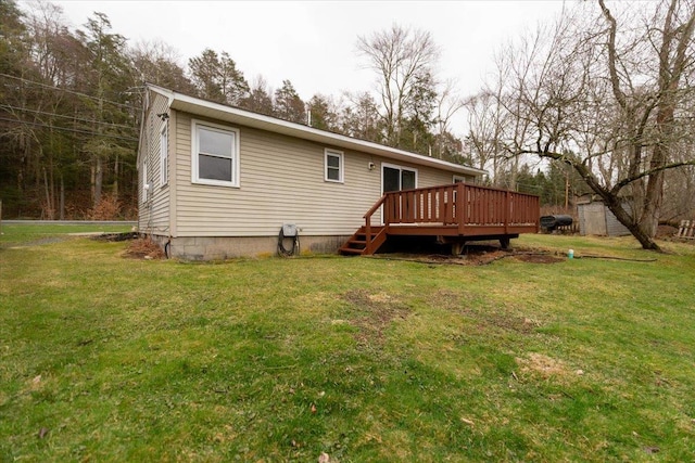 700 Sackett Lake Rd, Monticello, NY 12701 - rear view of house featuring a yard and a wooden deck