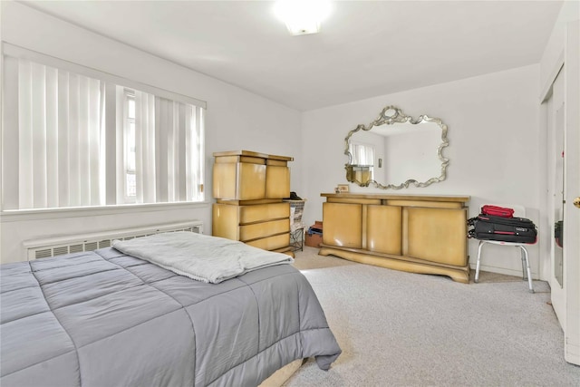 bedroom featuring radiator heating unit and carpet floors