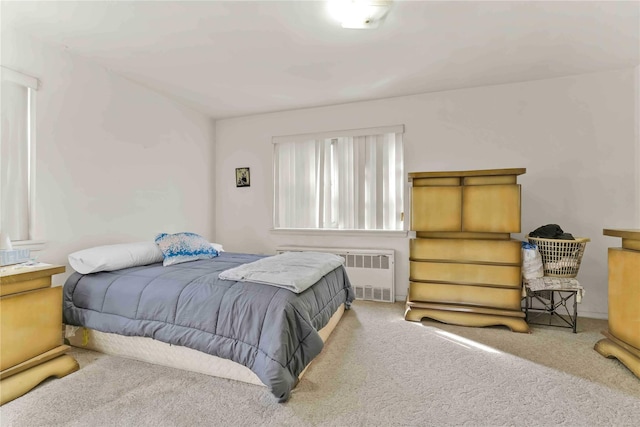 bedroom with radiator and carpet