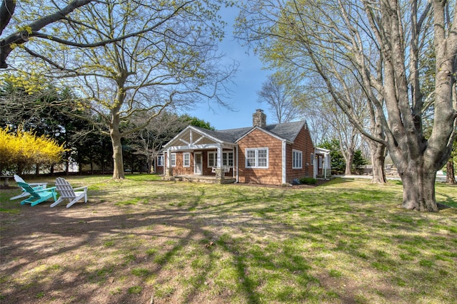 555 Three Waters Ln, Orient, NY 11957 - view of front of house with a front lawn, a porch, and a chimney