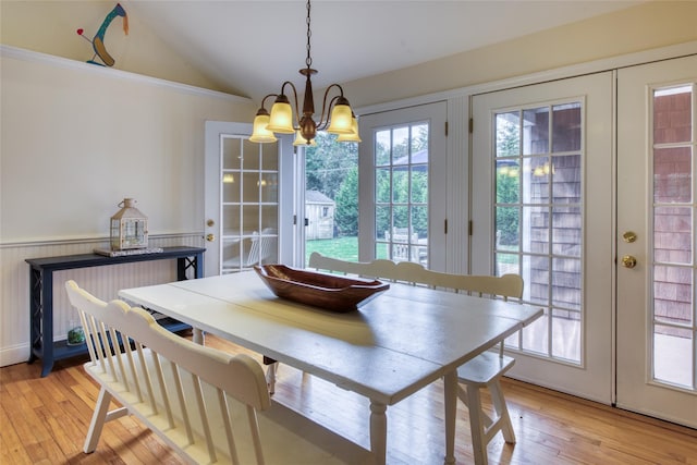 555 Three Waters Ln, Orient, NY 11957 - dining space featuring wainscoting, lofted ceiling, a notable chandelier, and light wood finished floors