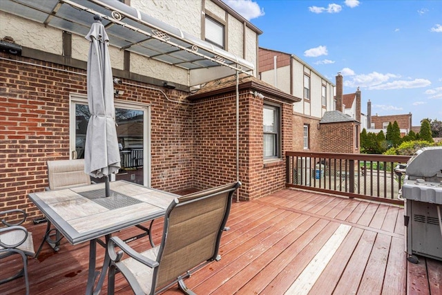 wooden terrace featuring grilling area