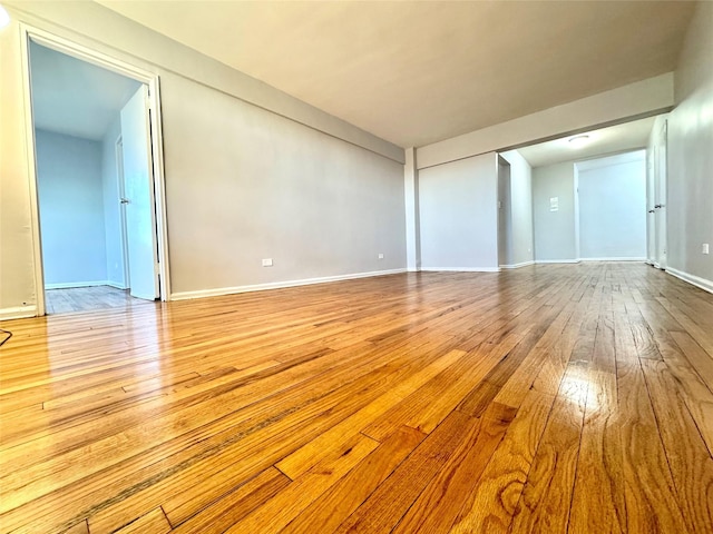 60-11 Broadway Unit 4C, Woodside, NY 11377 - unfurnished living room featuring hardwood / wood-style floors and baseboards