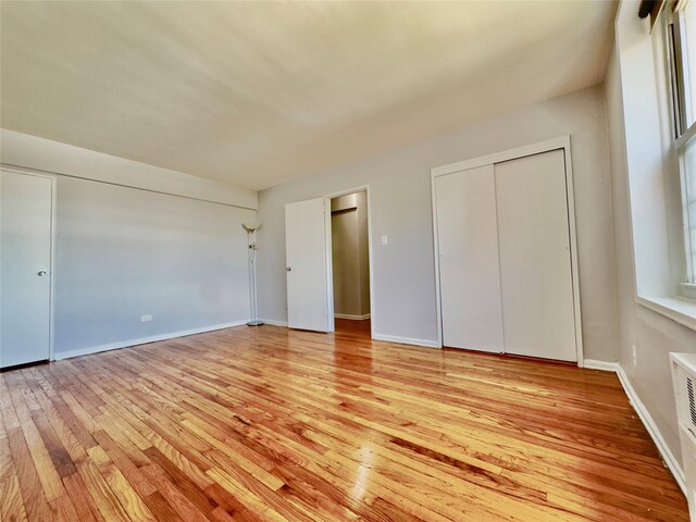 60-11 Broadway Unit 4C, Woodside, NY 11377 - unfurnished bedroom featuring light wood-style flooring and baseboards