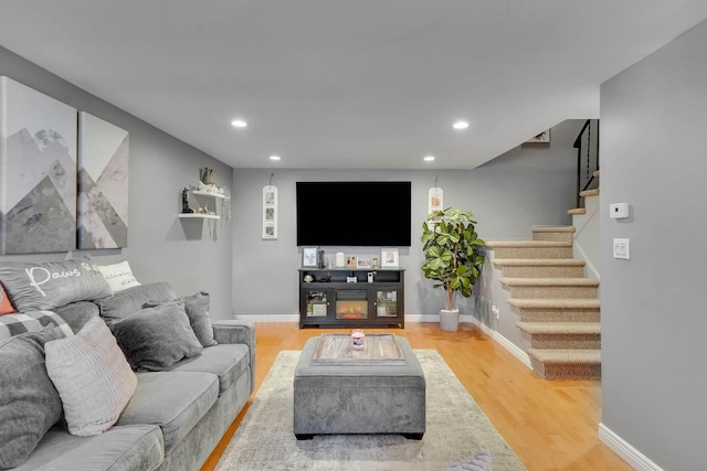living room with stairway, wood finished floors, recessed lighting, and baseboards