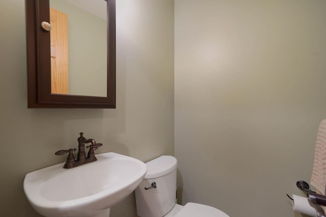 bathroom with toilet and a sink