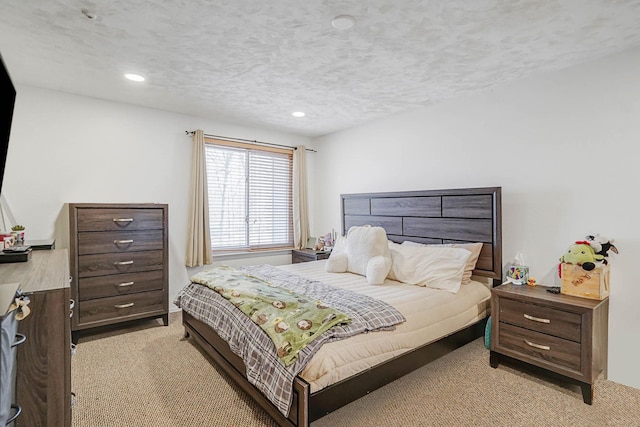 bedroom featuring light colored carpet, recessed lighting, and a textured ceiling