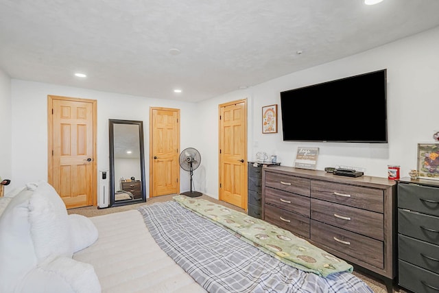 bedroom with light colored carpet and recessed lighting
