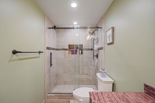 bathroom featuring baseboards, recessed lighting, a shower stall, and toilet