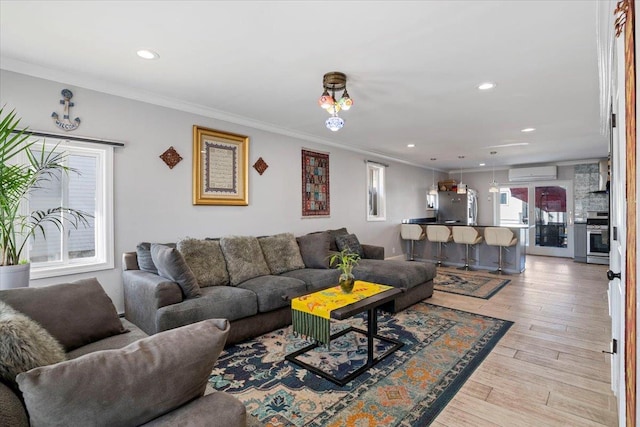 31 Arthur St, Baldwin, NY 11510 - living room with recessed lighting, light wood-style flooring, crown molding, and a wall unit AC